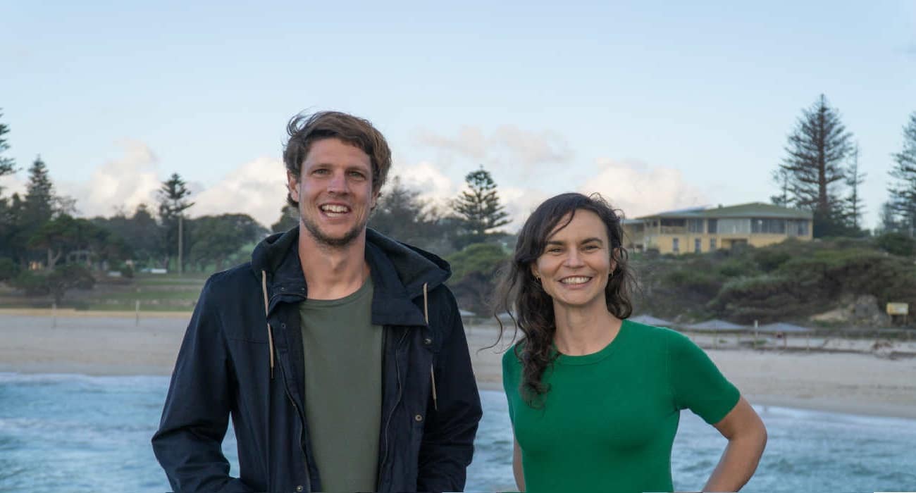 Uluu founders Julia and Michael stand at a beach