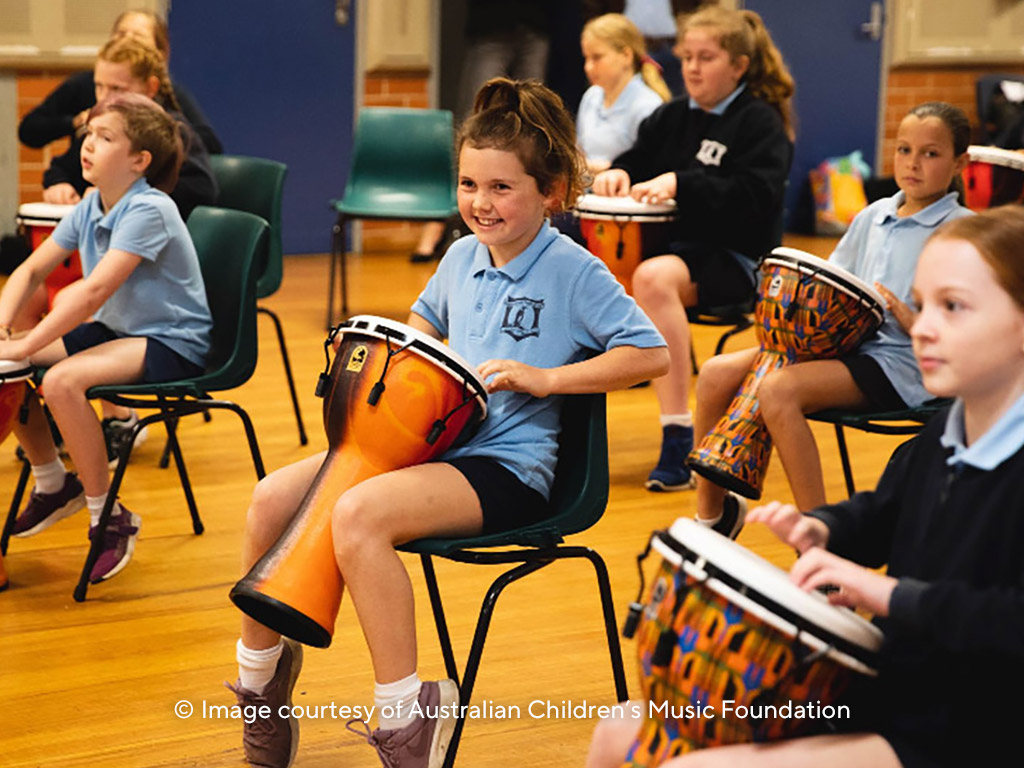School girls playing bongo drums
