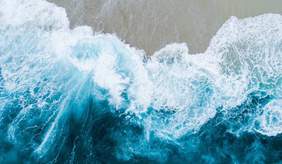 Overhead view of waves breaking on shore