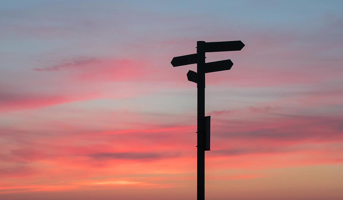 Signpost at sunset